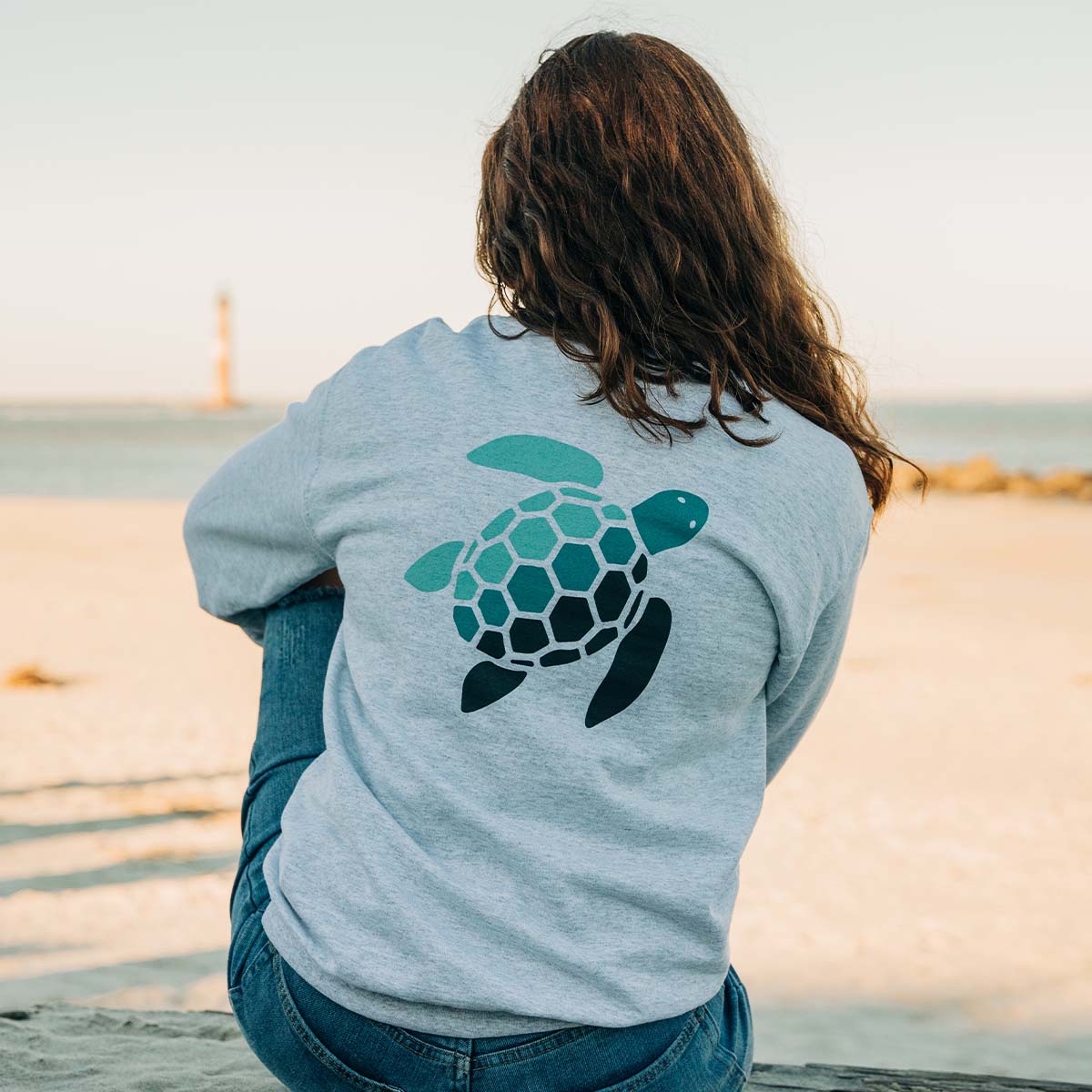 Soft Ash crew neck sweatshirt with Sea Green Apparel navy rectangle logo on front center and blue gradient Sea Green Apparel turtle logo on center back 8-ounce, 50/50 cotton/poly Double-needle stitching at waistband and cuffs 1x1 rib knit collar, cuffs and waistband with spandex