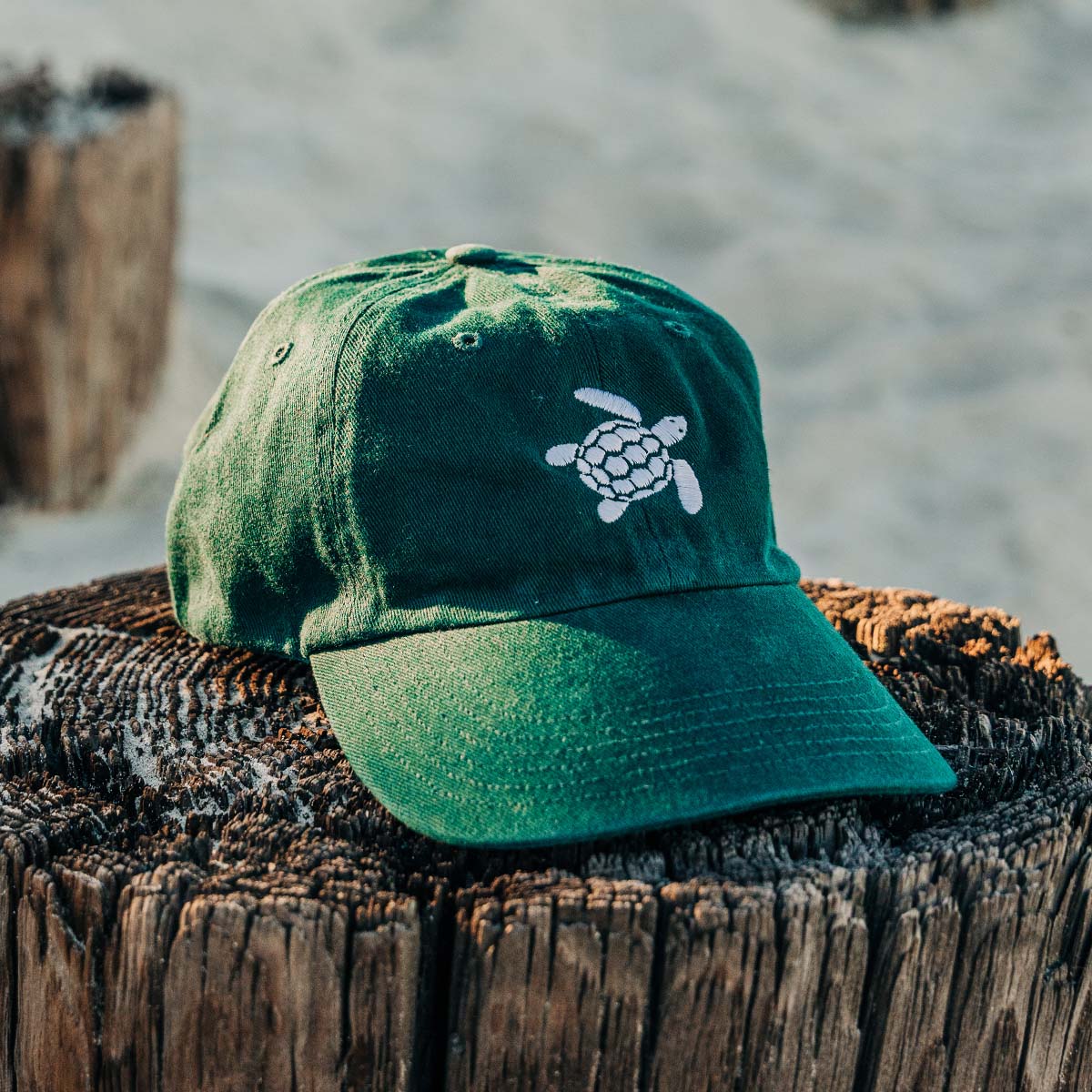 Green original turtle on front and green "Sea Green Apparel" embroidery on back 100% Cotton Twill Metal rivet on back Adjustable strap with buckle for comfortable wear